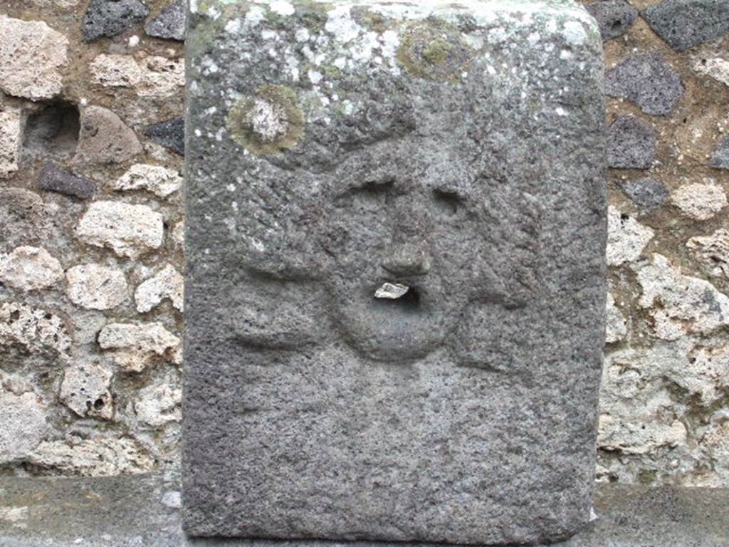 Fountain at VII.11.5 on Vicolo della Maschera. December 2005. Relief of tragic mask.