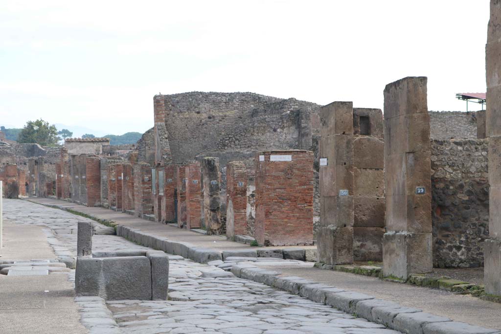 Fountain outside VII.14.13 and VII.14.14 on Via dell’Abbondanza, south side, Pompeii. December 2018. 
Looking east towards junction with Via dei Teatri, and Insula VIII.4, on left and VIII.5, on right. Photo courtesy of Aude Durand.