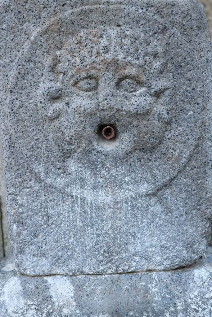 Fountain outside VIII.7.30. December 2018. 
Relief of medallion with Triton on pilaster. Photo courtesy of Aude Durand.