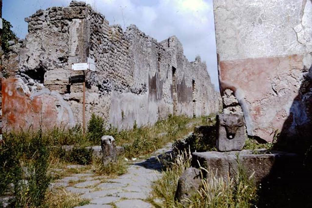 Fountain on Vicolo di Tesmo outside IX.7.17. 1964. 
Looking north to junction with Vicolo di Balbo, on the left, and IX.7, on the right at rear of fountain. Photo by Stanley A. Jashemski. 
Source: The Wilhelmina and Stanley A. Jashemski archive in the University of Maryland Library, Special Collections (See collection page) and made available under the Creative Commons Attribution-Non-Commercial License v.4. See Licence and use details.
J64f1602