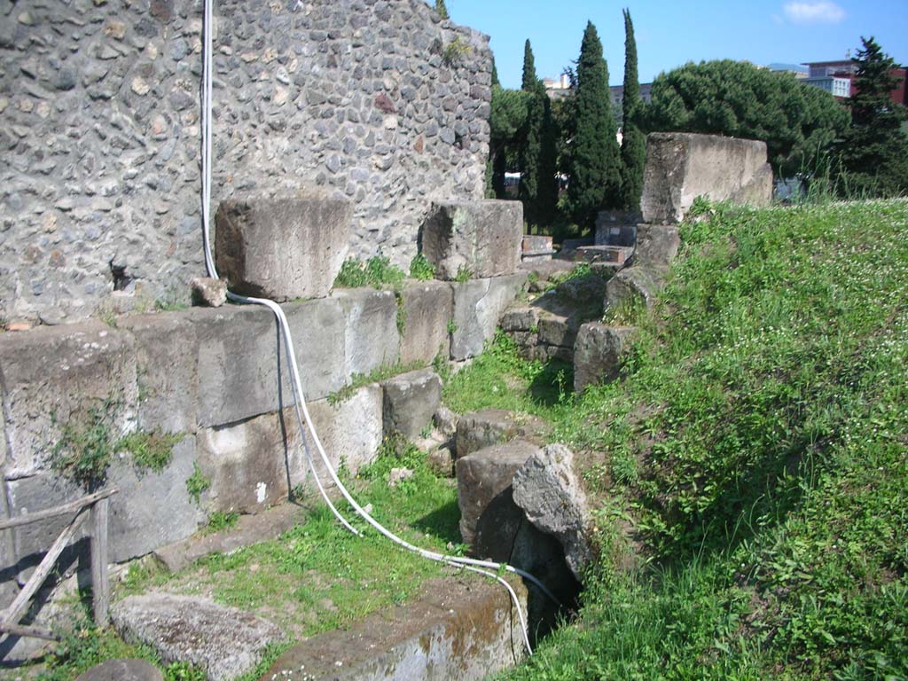 Porta di Nocera or Nuceria Gate, Pompeii. May 2010. 
Looking south along west exterior wall, and site of drain, lower centre. Photo courtesy of Ivo van der Graaff.