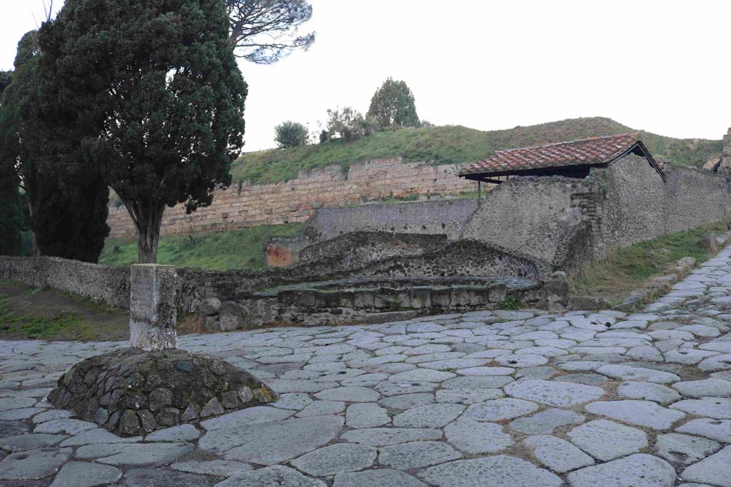 Pompeii Porta di Nocera. December 2018. 
Looking north-west at junction with Via delle Tombe, with cippus of Titus Suedius Clemens, on left. Photo courtesy of Aude Durand.