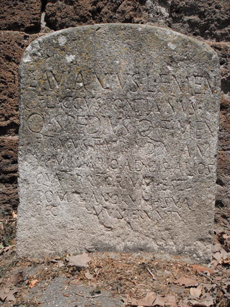Porta Stabia, Pompeii. May 2011. 
Detail from Cippus of L. Avianius Flaccus and Q. Spedius Firmus against south wall on east side. Photo courtesy of Ivo van der Graaff.
According to Van der Graaff –
“At the Porta Stabia the renovations conducted by the duumviri L. Avianius Flaccus and Q. Spedius Firmus included the construction of a raised causeway in front of the gate to ease cart traffic from the bustling river port nearby (Note 64).
The new roadway compromised the natural drainage of rainwater through the passageway, eventually leading to the construction of a sewer through the western agger that demolished the stairs leading up to the wall-walk (note 65).
The causeway also bridged the defensive ditch in front of the gate, thereby significantly reducing its military effectiveness.”
See Van der Graaff, I. (2018). The Fortifications of Pompeii and Ancient Italy. Routledge, (p.126).
