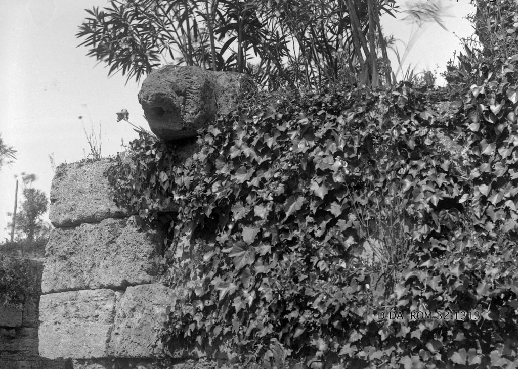 Porta Stabia. 1932. Lion spout. 
Photo by Erich Pernice.
DAIR 32.1313. Photo © Deutsches Archäologisches Institut, Abteilung Rom, Arkiv. 
According to Van der Graaff –
“Starting in 1874 through the end of the century, excavations resumed to expose the area in front of the gate. 
In addition to various tombs, excavators recovered a spout fashioned from a tuff block carved in the shape of a lion’s head. 
At first they identified it as the keystone to the gate vault, until August Mau recognized it as a spout that he believed was one of many that functioned to drain the wall-walk (Note 57).
Simpler versions of such spouts are indeed still present in the fortifications, but the lion head was a unique example that has since vanished (Note 58).
It may have functioned as a distinctive marker for the gate.” 
See Van der Graaff, I. (2018). The Fortifications of Pompeii and Ancient Italy. Routledge, (p.16).