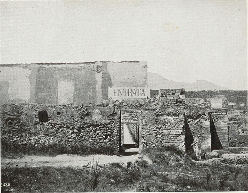 VIII.7.16 Pompeii. c.1907-1908. Photograph titled “Attuale entrata dal ludo gladiatorio”.
Looking north to small entrance at exterior south-east corner of Gladiator’s Barracks, an original entry to excavations of Pompeii.
According to Sogliano –
“………..and the very petty and inconvenient entry into Pompeii, made a few years ago, from a narrow corner of the Ludo Gladiatorium.  I will take care of this last filthy situation immediately, transferring the entrance to the Porta di Stabia, in the same way as one accesses the excavations by the Porta Marina and the Porta Nola.”
See Sogliano, A. (1908). Dei lavori eseguiti in Pompei dal 1 Aprile 1907 a tutto Giugno 1908. (p. 16 and fig. 7).