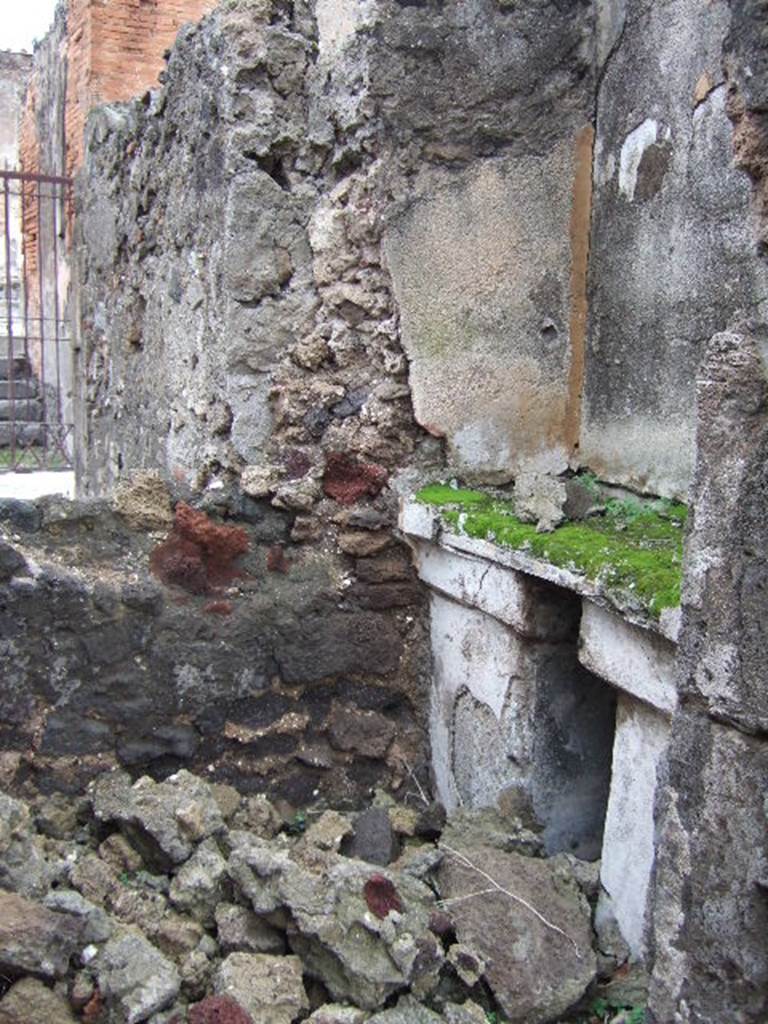 VII.9.47 Pompeii. December 2005. Room 10, sacellum.
According to PPM, a masonry altar was built in a recess against the east wall supported by two massive pillars which were painted in black: 
the middle zone of the wall painted above, was in yellow.
See Pompei: Pitture e Mosaici, Vol. VII  parte 1, Roma: Istituto della enciclopedia italiana, (p.364)