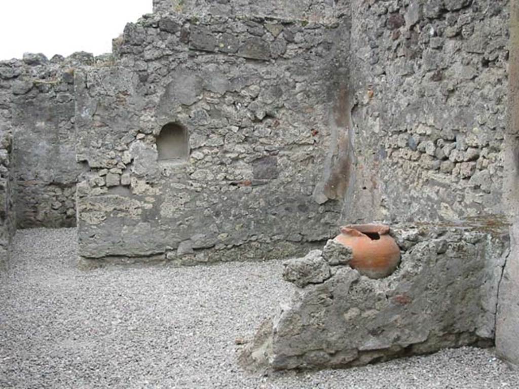 VII.9.49 Pompeii. May 2003. Looking south through entrance doorway. Photo courtesy of Nicolas Monteix.
According to Boyce –
in the south wall of this taberna with thermopolium is an arched niche (h.0.45, w.0.35, d.0.25, h. above floor 1,10. 
It was called by Fiorelli, “la nicchia dei Penati”.
See Boyce G. K., 1937. Corpus of the Lararia of Pompeii. Rome: MAAR 14. (p.69, no.305).