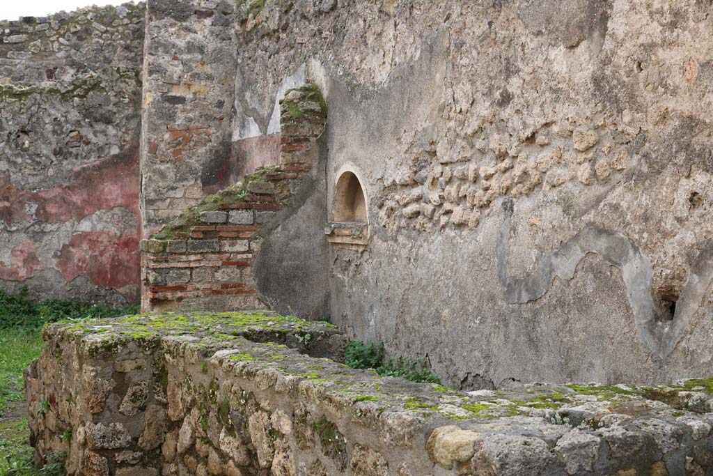 VII.12.15, Pompeii. December 2018. 
Looking south from entrance doorway towards counter with hearth, and niche in west wall. Photo courtesy of Aude Durand.