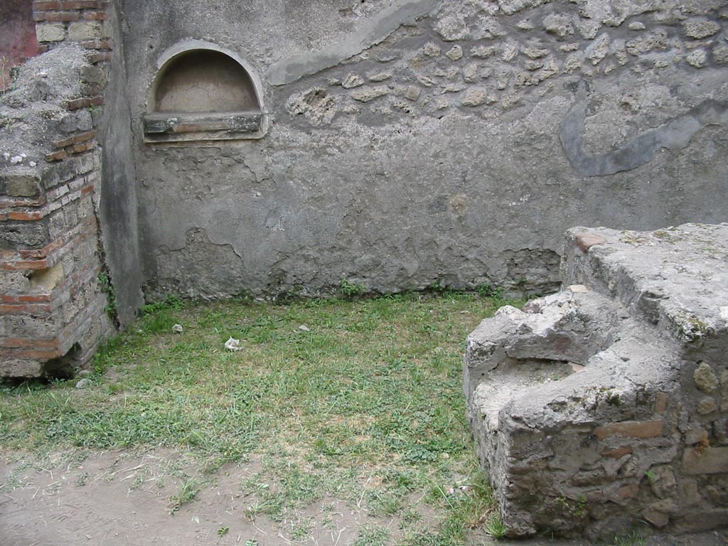 VII.12.15 Pompeii. May 2003. 
Looking towards west wall, with niche. At the end of the counter, the hearth can be seen. Photo courtesy of Nicolas Monteix.