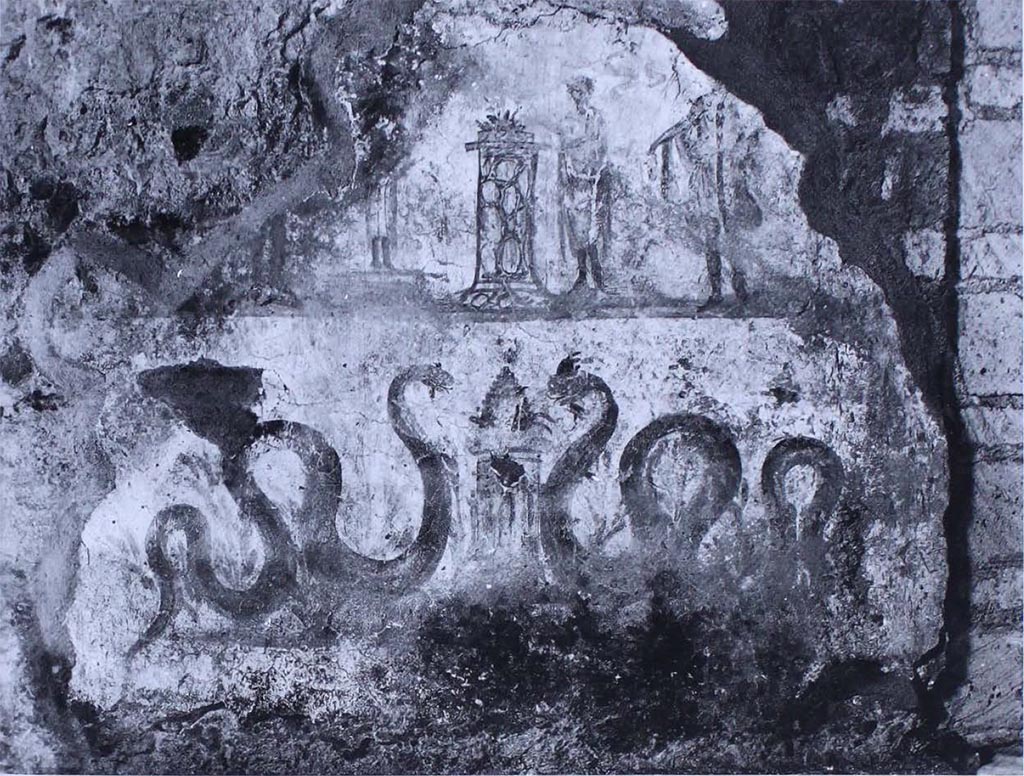 VII.16.22 Pompeii. Lararium painting on south wall of room 28.
The scene is divided, as frequently, between a lower area, with snakes on the sides of an altar, and an upper area, in which the Lares are represented (the one on the left is almost completely lost), who assist the sacrifice at an altar.
As is known, this is a type of decoration that was renewed very frequently, and it is therefore very probable that this lararium can be assigned to the last years of the city.
See Carratelli, G. P., 1990-2003. Pompei: Pitture e Mosaici. Roma: Istituto della enciclopedia italiana, (p. 977, no. 51.)