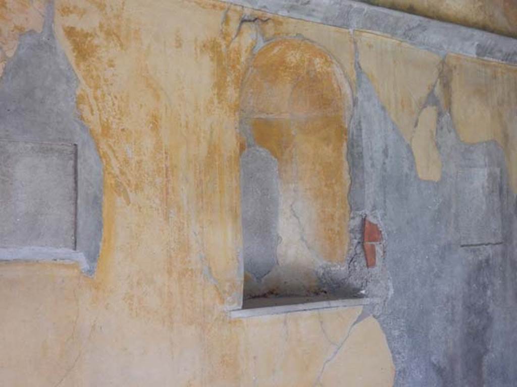 VIII.3.14 Pompeii. May 2016. Detail of niche in south wall. Photo courtesy of Buzz Ferebee.
According to Boyce – 
In the south wall of the cubiculum is a semicircular vaulted niche (h.1.00, w.0.60, d.0.30, h. above floor 1.40), its inside walls coated with yellow stucco like the walls of the room, its floor a marble slab; Fiorelli calls it “una nicchia per qualche simulacro di deita”.
See Fiorelli, Descr., 326.
See Boyce G. K., 1937. Corpus of the Lararia of Pompeii. Rome: MAAR 14. (p. 75, no. 352).