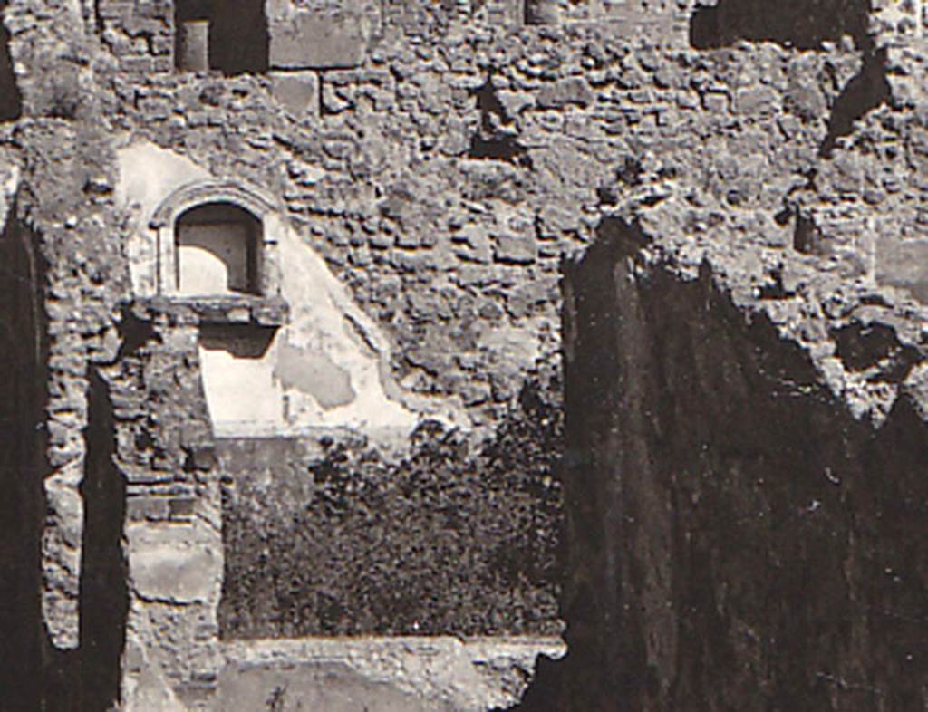 VIII.3.21 Pompeii. Detail of niche and garden from postcard dated 1st August 1939. Photo courtesy of Drew Baker.
According to Boyce- 
in the north wall of the garden was an arched niche (h.0.55, w.0.50, d.0.25, h. above floor 1.40) adorned with an aedicula façade.
The façade had a modelled stucco cornice running around the curve of the arch instead of a pediment.
It also had a heavy ledge projecting (0.19) from the surface of the wall. 
The inside walls of the niche were covered with white stucco and outlined with red stripes.
See Boyce G. K., 1937. Corpus of the Lararia of Pompeii. Rome: MAAR 14. (p.76, no.356, & Pl.3,5 photo by Warscher).
See Giacobello, F., 2008. Larari Pompeiani: Iconografia e culto dei Lari in ambito domestico. Milano: LED Edizioni, (p.282 no.V73)