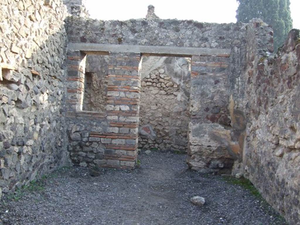 VIII.4.10 Pompeii. December 2007. Looking south to rear room.
According to Boyce –
In the south wall of the main room, a window was walled up, and a niche thus formed, to serve, according to Fiorelli, as a lararium. 
Fiorelli, Giorn. Scavi, 1861, 105; Scavi, 4; Descr., 339.
See Boyce G. K., 1937. Corpus of the Lararia of Pompeii. Rome: MAAR 14.  (p.76)
See Pappalardo, U., 2001. La Descrizione di Pompei per Giuseppe Fiorelli (1875). Napoli: Massa Editore. (p.128)