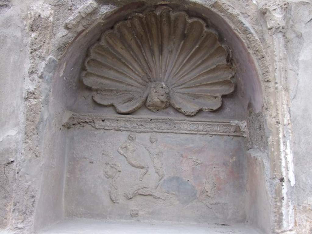IX.1.7 Pompeii. December 2007. Detail of niche with stucco of a shell and figures. According to Giacobello, the stucco figures are of Aphrodite and Eros on a seahorse. See Giacobello, F., 2008. Larari Pompeiani: Iconografia e culto dei Lari in ambito domestico.  Milano: LED Edizioni. (p.247).