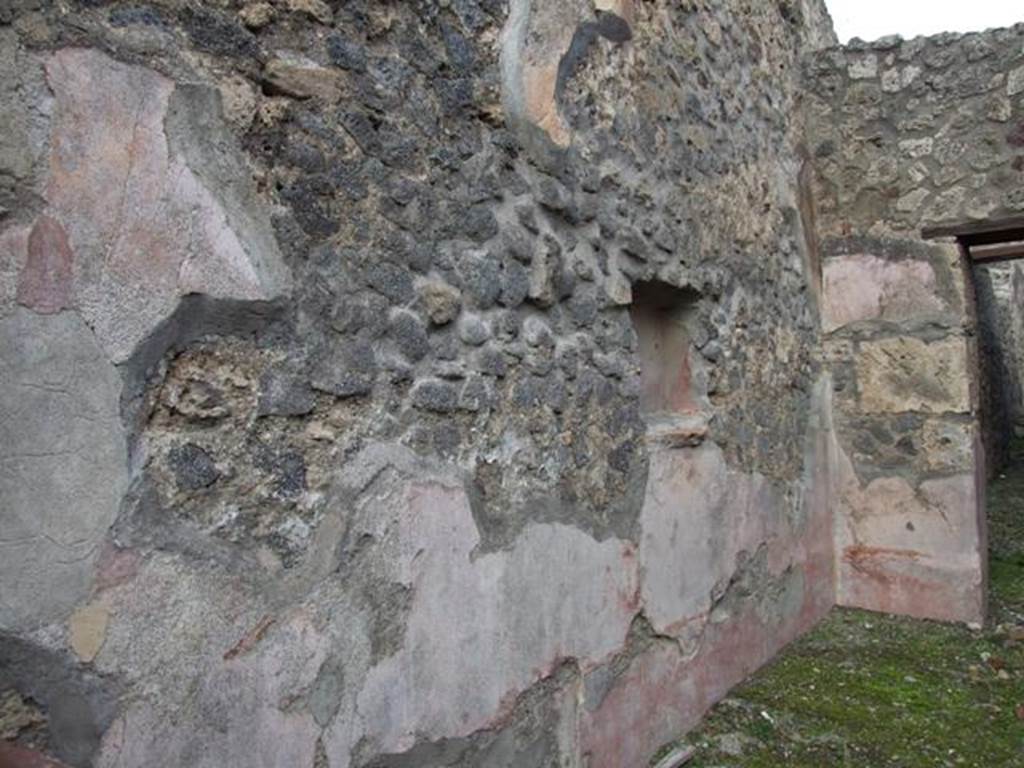 IX.2.12 Pompeii. December 2007. North wall of shop with remains of plaster. According to PPP, the red plaster of the zoccolo was seen painted with plants in panels. The upper zone of the wall was faded and discoloured but showed traces of subdivision into panels.
See Bragantini, de Vos, Badoni, 1986. Pitture e Pavimenti di Pompei, Parte 3. Rome: ICCD. (p.412)