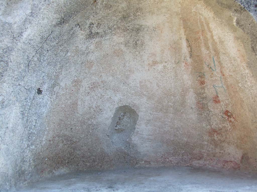 IX.3.2 Pompeii. March 2009. Garden area. Niche in south wall. The niche was originally decorated with yellow, red and green flowers.
See Giacobello, F., 2008. Larari Pompeiani: Iconografia e culto dei Lari in ambito domestico. Milano: LED Edizioni. (p.284, no.V78).
According to Boyce, in the south wall of the peristyle is a vaulted semi-circular niche (h.0.48, w.0.62, d.0.35, h. above floor 1.65).
The inside walls were decorated on a white background with red and yellow spots and outlined with red stripes.
The two Lares were painted on the wall above the niche and below it the serpents, confronted at an altar.
Bronze statues were found in the niche on 12th July 1847: a female figure, a male figure, Hercules, Jupiter, and Isis-Fortuna.
See Boyce G. K., 1937. Corpus of the Lararia of Pompeii. Rome: MAAR 14. (p. 82, no. 406, Pl. 4, 2.) 
Helbig also gave a description of the statuettes found in the niche:
See Helbig, W., 1868. Wandgemälde der vom Vesuv verschütteten Städte Campaniens. Leipzig: Breitkopf und Härtel. (69b)