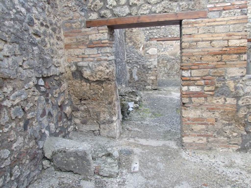 IX.3.13 Pompeii. March 2009. North wall of caupona, with remains of stairs in north-west corner, and doorway to dwelling.
On the west wall, on the left, under the stairs would have been a lararium painting, now disappeared.
Luckily both Fiorelli and Sogliano wrote a good description. 
Fiorelli told us that there was a Genius flanked by Lares, the caricature of a male head, and two gladiators in combat. 
Sogliano reported that the painting was done in red monochrome on white plaster, and showed a Genius with patera and cornucopia, sacrificing at the altar in the middle of two Lares with rhyton and situla. 
See Pappalardo, U., 2001. La Descrizione di Pompei per Giuseppe Fiorelli (1875). Napoli: Massa Editore. (p. 146).
See Sogliano, A., 1879. Le pitture murali campane scoverte negli anni 1867-79. Napoli: (p.11).
According to Boyce –
On the wall of the shop is a lararium painting (h.0.80 by w.1.20) representing the Genius with cornucopia and patera beside an altar and on each side a Lar with rhyton and situla.
See Boyce G. K., 1937. Corpus of the Lararia of Pompeii. Rome: MAAR 14. (p.83-4, no. 411). 
See Jacobelli, L., 2003. Gladiators at Pompeii. Rome: L’Erma di Bretschneider. (p. 82).