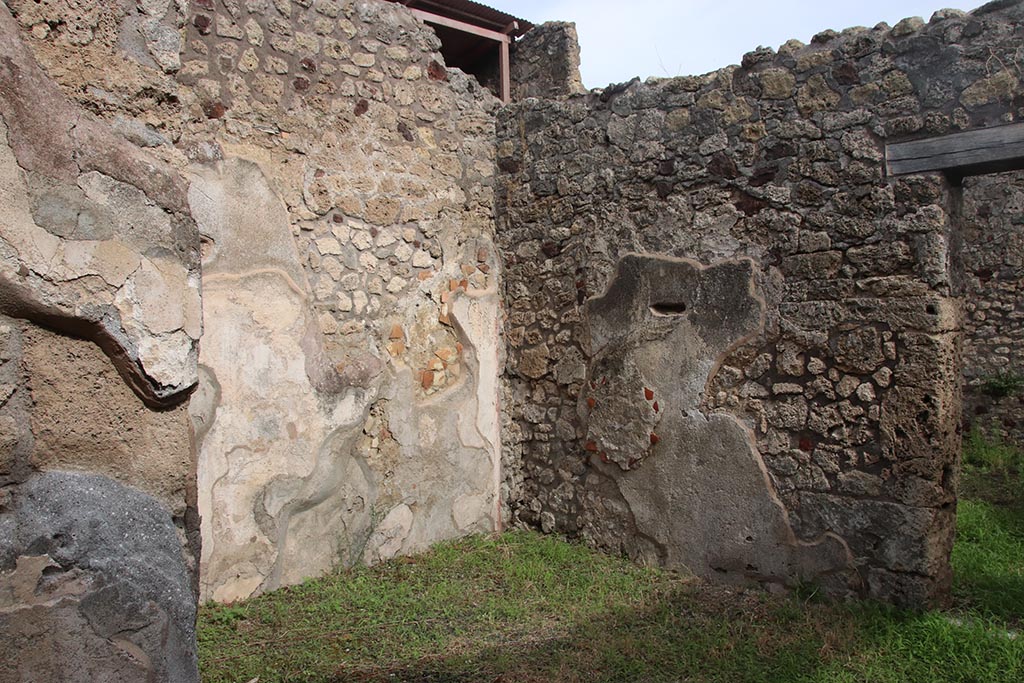 IX.7.19 Pompeii. October 2024. Looking north-east in ala c towards east wall, on right. Photo courtesy of Klaus Heese.
According to Boyce, on the east wall of the left ala, a fragment of a lararium painting was seen at the time of excavation.
The fragment represented a single serpent moving amongst foliage.
See Boyce G. K., 1937. Corpus of the Lararia of Pompeii. Rome: MAAR 14. (p.88, no.437)  
See Fröhlich, T., 1991. Lararien und Fassadenbilder in den Vesuvstädten. Mainz: von Zabern. (p.112).