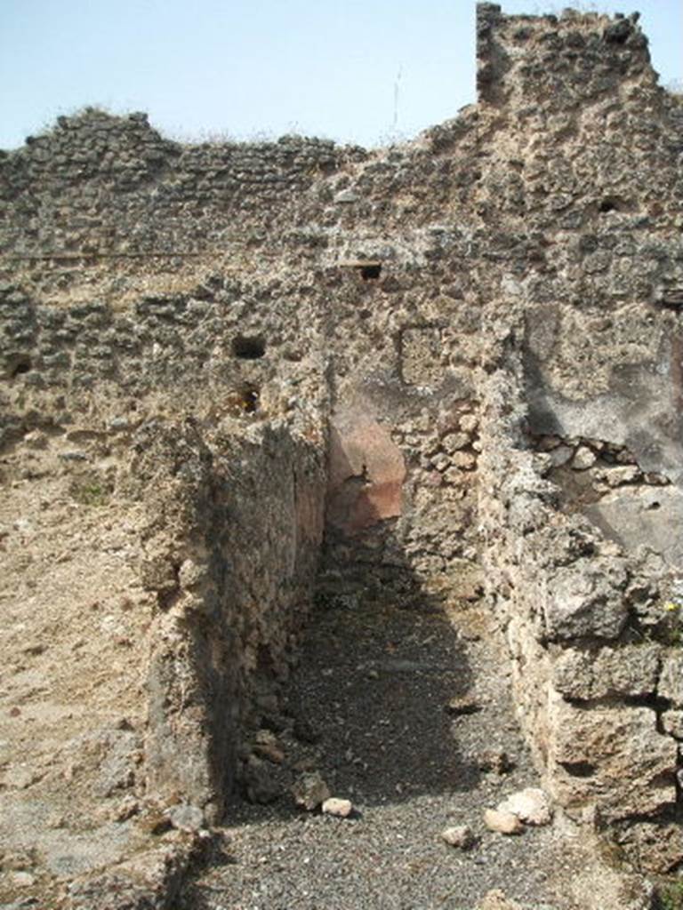 Pompeii. May 2005. Corridor leading to latrine. Looking west. According to Boyce, on the south wall of the passage leading to the latrine was painted the figure of Fortuna. See Boyce G. K., 1937. Corpus of the Lararia of Pompeii. Rome: MAAR 14. (p.88, no.442 and Pl. 26,2)