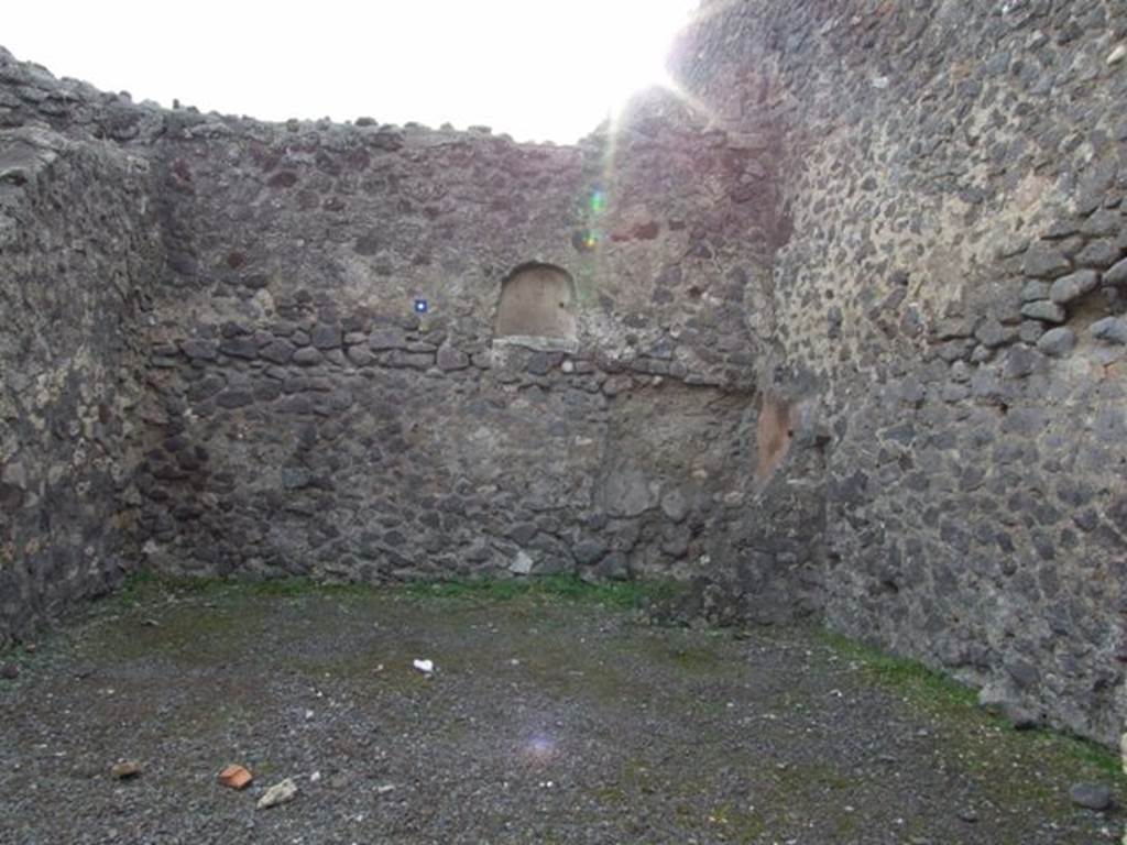 IX.8.1 Pompeii. December 2007. Looking towards south wall and niche in shop.
According to Boyce, in the north wall of the main room was an arched niche (h.0.48, w.0.54, d.0.33, h. above floor 1.65.
Its walls were coated with white stucco.
See Boyce G. K., 1937. Corpus of the Lararia of Pompeii. Rome: MAAR 14. (p. 89, no. 447).