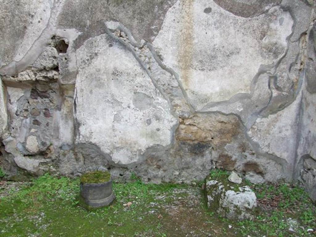IX.8.7 Pompeii. March 2009. South wall, with stone base of stairs, and line of stairs visible in the plaster.
According to Boyce, on the south wall beneath the stairs leading to the upper floor, a panel (h.0.95, w.1.10) of white stucco was bordered with red stripes.
On this panel was painted a single serpent, advancing left towards a burning altar, which stood amongst plants.
See Notizie degli Scavi di Antichità, 1880, 98.
See Boyce G. K., 1937. Corpus of the Lararia of Pompeii. Rome: MAAR 14. (p.90, no.450)
