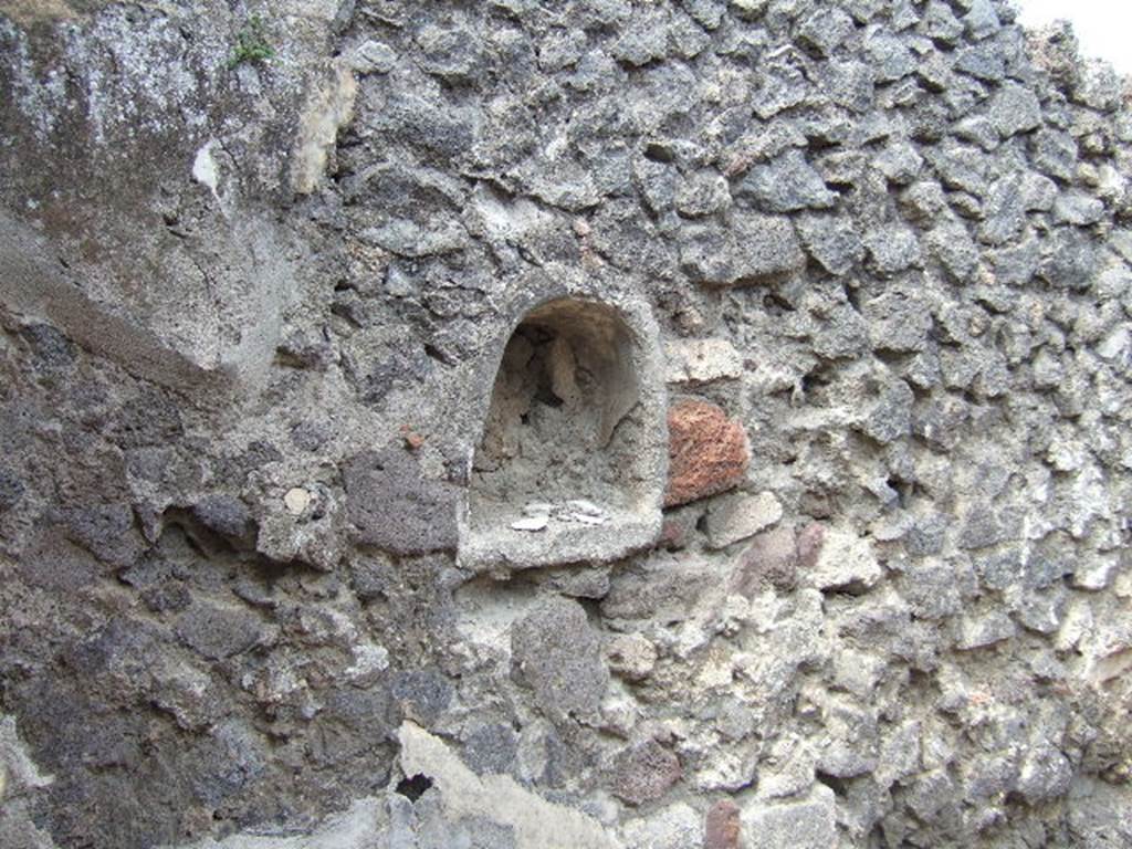 IX.9.6 Pompeii. May 2006. Niche in west wall of cubiculum.
According to Boyce – 
this niche (h.0.45, w.0.41, d.0.18, h. above floor 1.27) had walls coated with white stucco decorated with green, yellow and violet spots, probably representing flowers.
See Boyce G. K., 1937. Corpus of the Lararia of Pompeii. Rome: MAAR 14. (p. 91 no. 457)