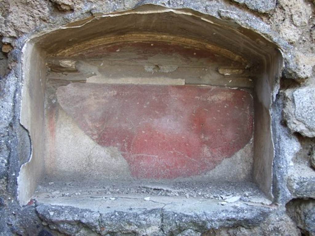 IX.9.13 Pompeii. March 2009. 
Lararium arched niche (h.0.50, w.0.65, d.0.25, h. above floor 1.50) in the south-west corner of room 6, garden.
The walls of the niche were coated with white stucco bordered in red, its back wall adorned with a stucco cornice.