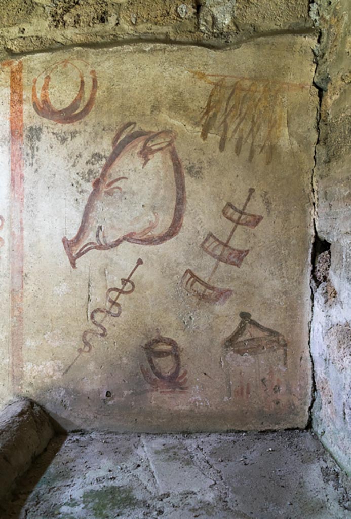 IX.9.c Pompeii. March 2023. 
East end of north wall of kitchen, wall painting of hanging birds, ring sausages, a pig’s head and meat on a stick.
Photo courtesy of Johannes Eber.