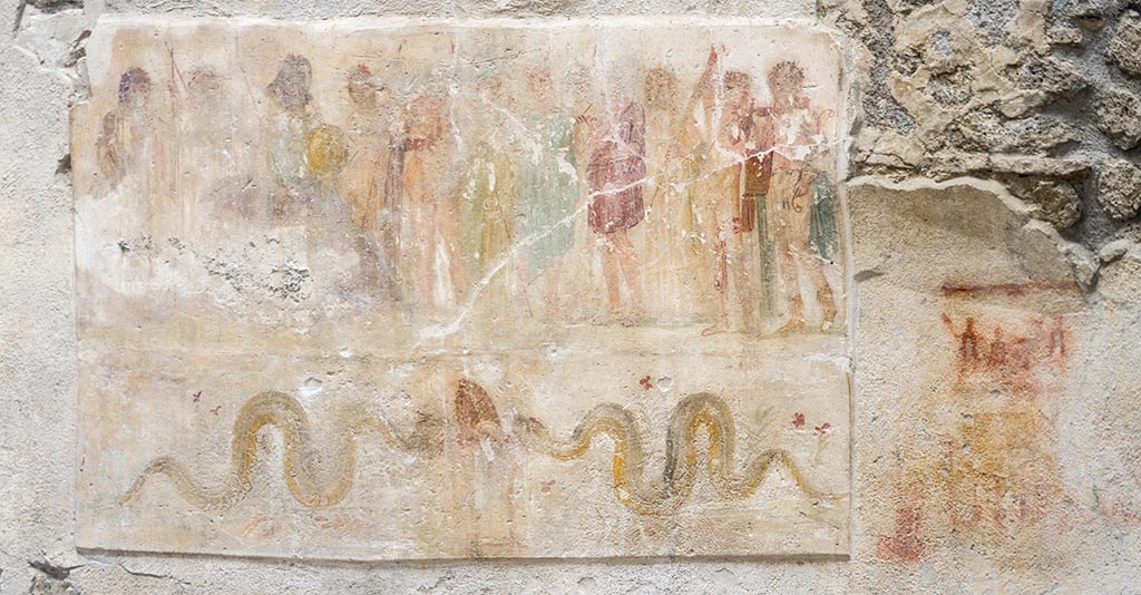 IX.12.6 Pompeii. July 2024. 
Room “n1”, lararium painting on west wall, showing Hercules being presented to the twelve gods in the upper part.
Underneath are two serpents approaching an altar.
To the right are the remains of a possible preparatory sketch for a lararium painting?
Photo courtesy of Johannes Eber.