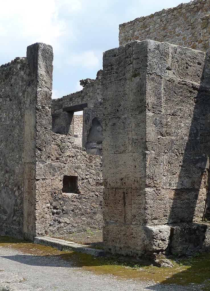 IX.14.3 Pompeii. May 2010. Entrance doorway looking to east wall.
According to Boyce, in the east wall was a square niche painted white within.
See Notizie degli Scavi di Antichità, 1911, 351.  
Boyce gives the location as Reg. III, Taberna located to the east of the entrance into the smaller atrium of Domus Obelli Firmi.
See Boyce G. K., 1937. Corpus of the Lararia of Pompeii. Rome: MAAR 14. (p. 31, no. 69)