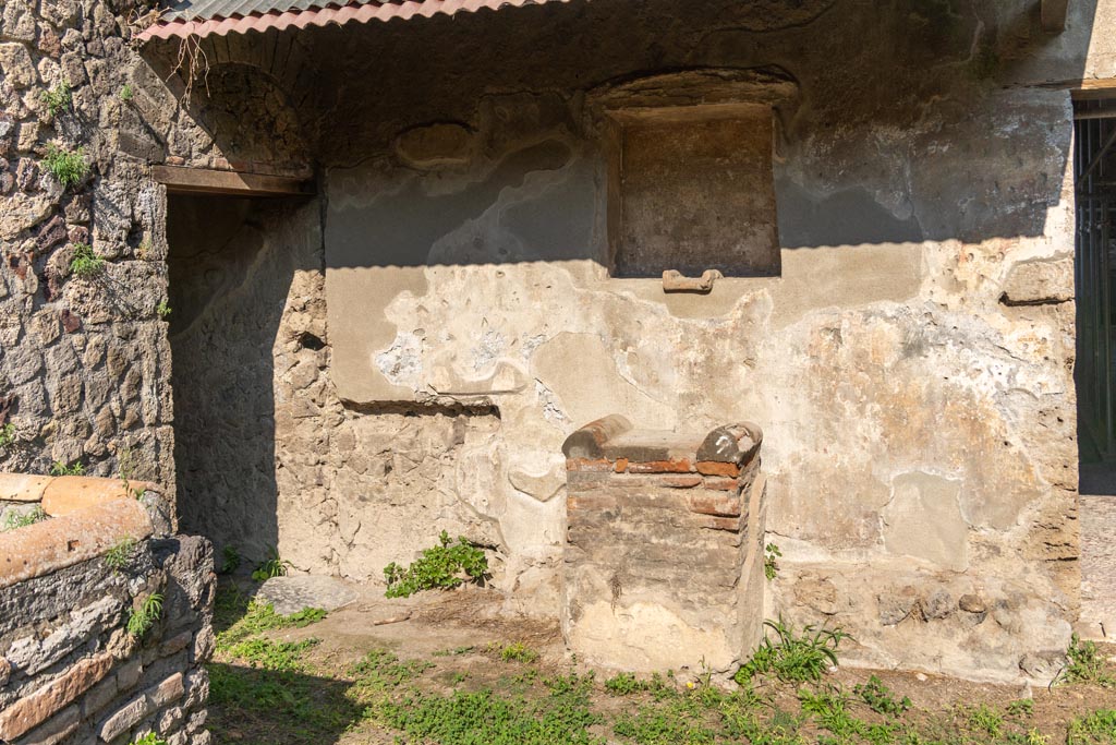 Villa of Mysteries, Pompeii. October 2023. 
Room 61, kitchen courtyard. North side with lararium niche and altar. Photo courtesy of Johannes Eber.