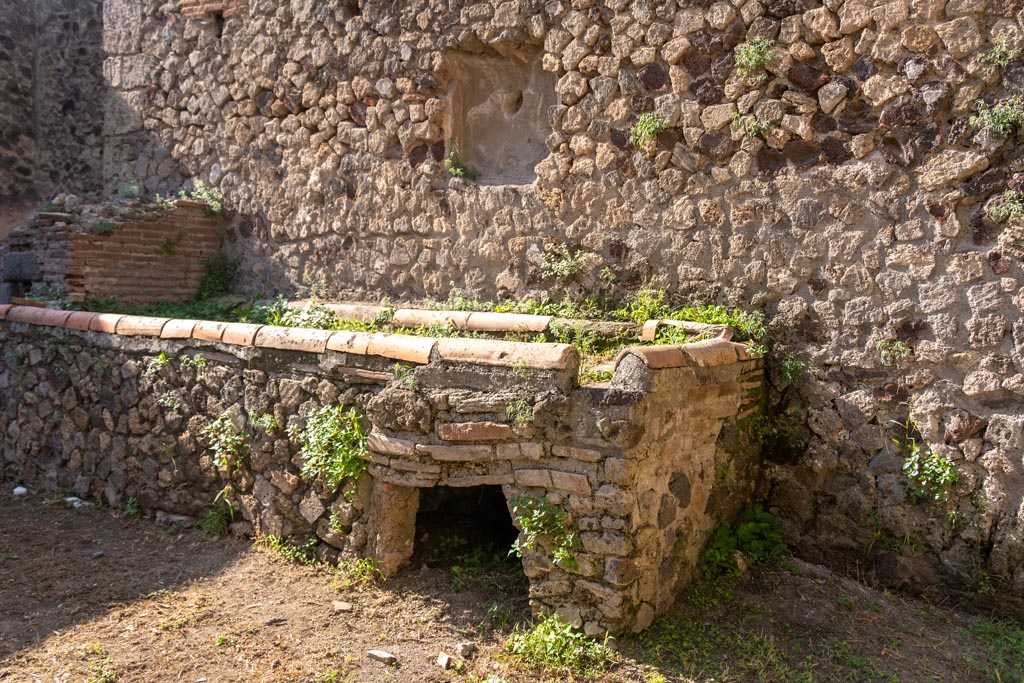 Villa of Mysteries, Pompeii. October 2023. 
Room 61, west wall with hearth and oven, and remains of niche. Photo courtesy of Johannes Eber.