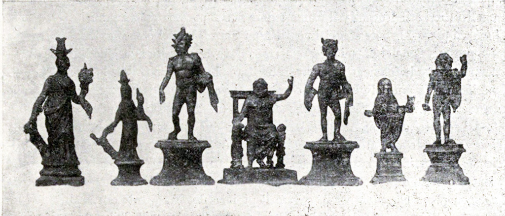 Boscoreale, La villa del Fondo Acunzo. 1903. Room 12.  Podium “y”.
Group of seven bronze statuettes found on podium built against the east wall of the room which opened off the kitchen 8: 
Centre: Jupiter seated
To the left: Helios with radiant crown
Furthest left: Two figures of differing sizes representing Isis-Fortuna
To the right of Jupiter: Mercury or a young nude faun with pan pipes 
Further right: Genius familiaris wearing a toga
Right hand end: Standing Jupiter or Neptune with arm raised
See Notizie degli Scavi di Antichità, 1921, p. 440-1, fig.11.
See Boyce G. K., 1937. Corpus of the Lararia of Pompeii. Rome: MAAR 14.  (p.100, no.500B).