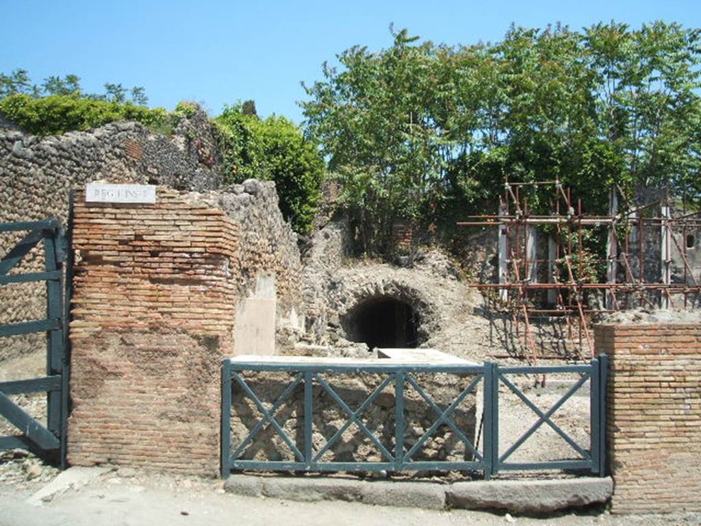 I.2.13 Pompeii. May 2005. Entrance doorway, looking east. On the right of the entrance doorway would have been the site of the south wall of the bar. This wall was destroyed in the 1943 bombing together with a niche or recess in the south wall. According to Boyce, on the wall was a lararium painting but only the lower parts of two figures (one a Lar) remained. Two serpents confronted at an altar with offerings.
See Boyce G. K., 1937. Corpus of the Lararia of Pompeii. Rome: MAAR 14. (p.22, no.7).  According to Sogliano, the sacred picture was destroyed (by 1879). See Sogliano, A., 1879. Le pitture murali campane scoverte negli anni 1867-79. Napoli: (p.19, no.65)