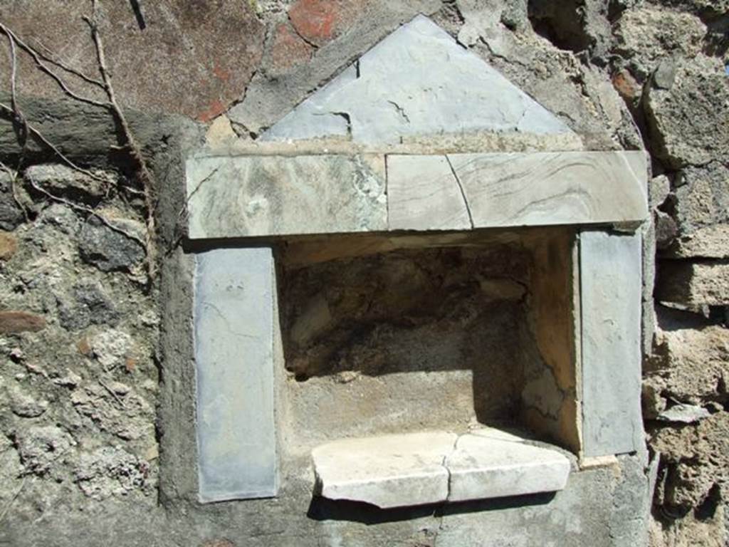 I.2.17 Pompeii. March 2009. Lararium niche of coloured marble, in east wall of fauces. According to Boyce, the walls, projecting floor and aedicula façade of this rectangular niche are all of greyish marble. In the floor were three holes for the bases of statuettes. See Boyce G. K., 1937. Corpus of the Lararia of Pompeii. Rome: MAAR 14.  (p.22 no.9, pl.7,2)