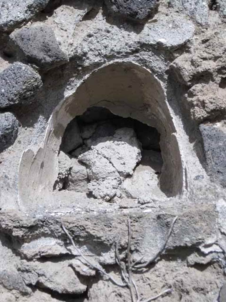 I.2.23 Pompeii. September 2010. Detail of niche on east wall. Photo courtesy of Drew Baker.
According to Boyce –
in the east wall of the main room was an arched niche (h.0.32, w.0.32, d.0.26, h. above floor 1.75).
See Boyce G. K., 1937. Corpus of the Lararia of Pompeii. Rome: MAAR 14. (p.23, no.15)