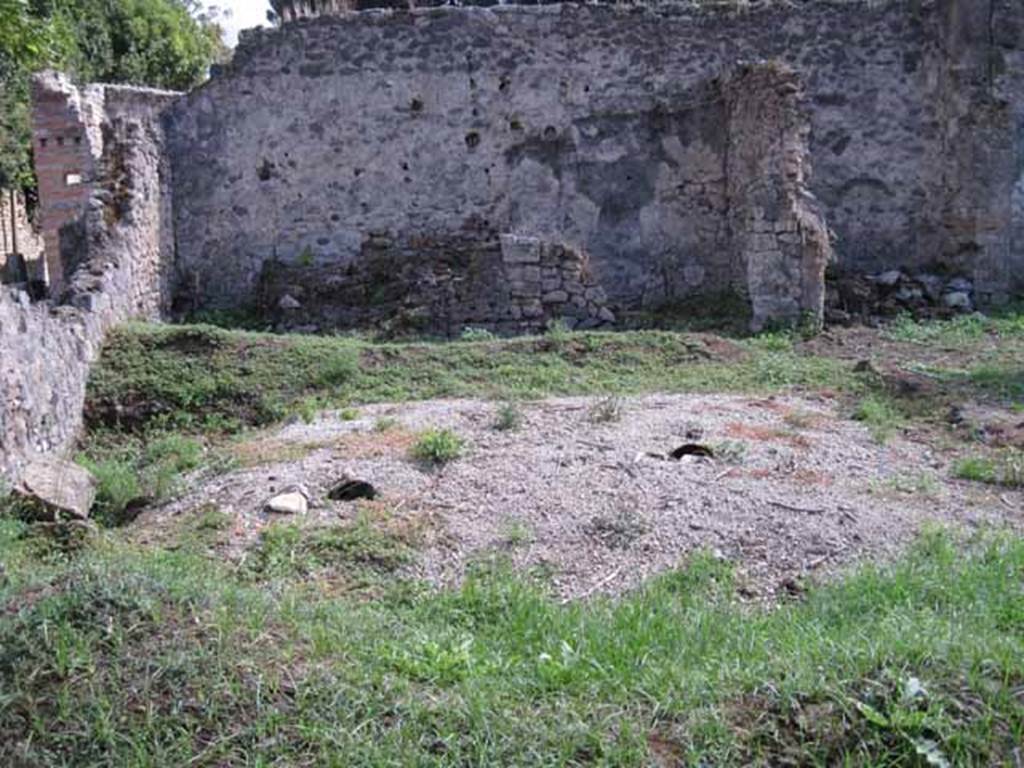 I.2.24 Pompeii. September 2010. 
Looking south across peristyle over remains of the triclinium, towards the three rooms on the south side. 
On the left could be the remains of the altar base.  Photo courtesy of Drew Baker.