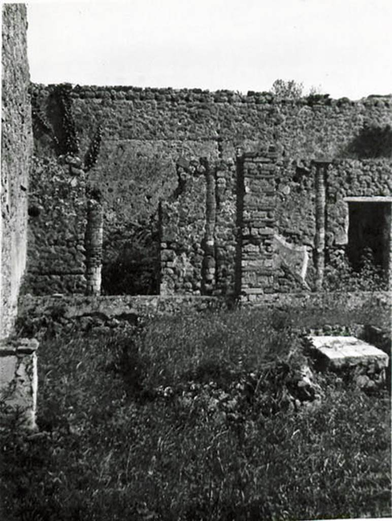 I.2.24 Pompeii. 1935 photo taken by Tatiana Warscher. Looking south across peristyle over remains of the triclinium, towards the rooms on the south side. On the left, the altar base can be seen, (see description from Boyce, on one of the photos above). 
See Warscher T., 1935. Codex Topographicus Pompeianus: Regio I.2. (no. 46), Rome: DAIR, whose copyright it remains.
According to Warscher, quoting Bull. Inst. 1874, p.255-256,  –
I.2.24. “Evidentemente in origine il peristilio aveva 6 colonne di mattoni verso O, e 4 verso S, congiunte da un muricciuolo alto m. 0,52, e coi suoi portici occupava tutta quella parte della casa, dimodochè intorno ad esso non vi erano camere, ad eccezione del triclinio, il quale benchè si apra sul peristilio, sta però piuttosto accanto all’atrio.
Più tardi però, quando si cercò di guadagnar più camere, qui pure, come in tante altre case, il peristilio dovette subire cambiamenti. L’estremità settentrionale, cioè del portico occidentale fu trasformata in una cameretta, nel cui muro orientale è conservata ancora una colonna. Tale cameretta ha la porta verso S ed una finestra verso E sul viridarium; nell’angolo SE di essa un rialzo di materiale mostra l’impressione d’un vaso rotondo.
Inoltre si inchiusero in un muro le colonne meridionali, trasformando quel portico in due camere, di cui la prima (da E serviva di cucina: vi si trova focolare, forno e cesso). 
Per supplire poi al portico così perduto, fra la penultima, adesso ultima, delle colonne occidentali e il muro orientale si costruì un pilastro quadrato: una trave, che congiunse colonna, pilastro e mura, dovette sorreggere il tetto dalla parte del viridario trasformata così in un portico. Più tardi soltanto quel pilastro fu congiunto col muro e colla colonna da un muricciuolo come quello del lato occidentale. - Tutti questi cambiamenti si riconoscono in modo indubitabile: I muri delle camere verso S sono appoggiati soltanto al muro meridionale, non congiunti con esso, e la stessa decorazione del peristilio continua nelle camere. Altri cambiamenti, che però ne’dettagli non è possibile di rintracciare, ci vengono accennati da una porta murata che all’estremità verso E del portico meridionale congiungeva una volta questo peristilio colla casa adiacente. - Presso l’angolo SO, accanto alle camere meridionali, una parte del suolo è innalzata un poco e inchiusa a linea curva verso E da un muricciuolo (alto m. 0,61 di fuori, 0,52 di dentro), del resto da un margine poco elevato; e chiara ne è la destinazione: vi si trovarono alcune anfore, appoggiate al muro. - Sul lato meridionale del pilastro summentovato troviamo la seguente iscrizione, la cui significazione sarà simile a quella dell’iscrizione de’librari; siccome però è scritta a carbone, così  non sene poteva leggere che questo:
Q  VERANIVS  RVFVS   C   POMIO  IIVS  CALVS
VEDIVS  SIRICVS           C             SANT       III
      RENTIVS FELIC                                                         (CIL IV. 3952)
(translation: I.2.24 “Evidently the original peristyle would have had 6 masonry columns towards the west side,  and 4 towards the south, joined by a wall 0,52m high, and with its porticoes covering all that part of the house, so around it there were no rooms, with the exception of the triclinium, which although it opened onto the peristyle, it was however rather near to the atrium. Later though, when more rooms were sought, as in many other cases, the peristyle underwent changes. The northern end of the western portico was altered into a room, in the east wall of which, a column was still preserved. This room had a door towards the south and a window towards the east onto the garden: in the south-east corner a prominence of material showed the impression of a round pot. Also enclosed into a wall were the southern columns, transforming this portico into two rooms, of which the first (from the east, used as a kitchen: hearth, oven and latrine).To compensate for the lost portico, a square pillar was built between the penultimate and last western columns and the eastern wall; a