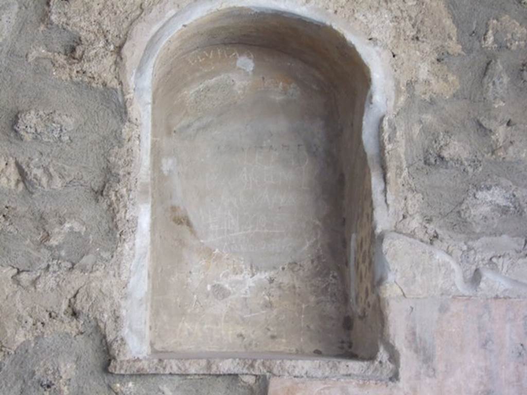 I.8.1 Pompeii. December 2007. Niche in west wall.
According to Boyce-
this niche (h.0.77, w.0.48, d.0.19, h. above floor 1.50) was painted yellow on the inside and surrounded by a border of yellow stucco, which formed a rectangle around the niche. Below it was a half-tile embedded in the wall to hold the offerings.
He quoted Not. Scavi, 1912, 404.
See Boyce G. K., 1937. Corpus of the Lararia of Pompeii. Rome: MAAR 14. (p.26 no.44).