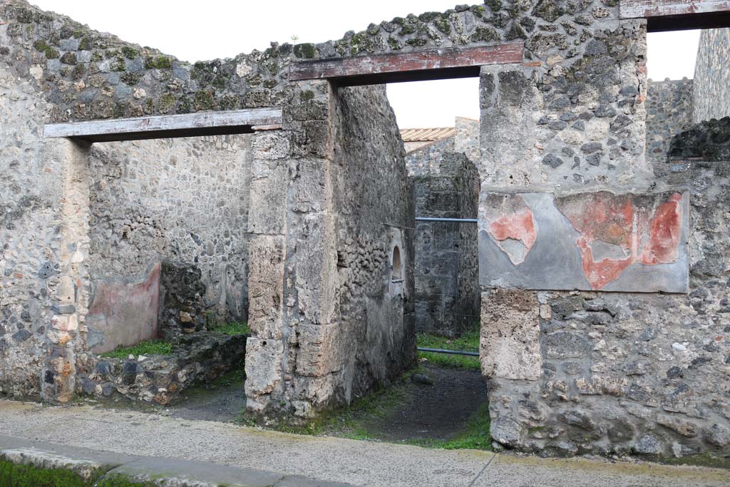 I.10.2 (on left) and I.10.3 Pompeii, (in centre). December 2018.  
Looking south on Vicolo del Menandro towards entrance doorways. Photo courtesy of Aude Durand.