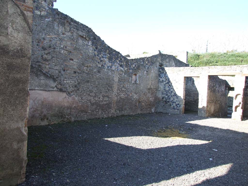I.11.8 Pompeii. December 2006. Looking north-west across atrium towards doorway at I.11.5.
On the right of the picture are two niches one above the other in the wall to east of entrance corridor.
On the left is a painted niche in the west wall.
