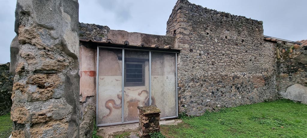 I.11.15 Pompeii. January 2023. 
Room 10, west wall of garden area with four-sided altar in front of painted lararium. Photo courtesy of Miriam Colomer.