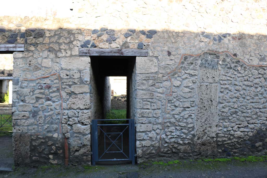 I.12.9 Pompeii. December 2018. Entrance doorway on north side of Via di Castricio. Photo courtesy of Aude Durand.