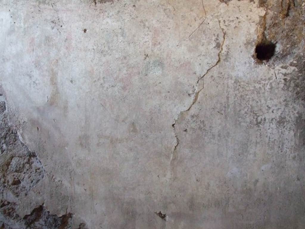 I.12.9 Pompeii. December 2007. East wall of kitchen. According to PPP and Giacobello, on the east wall of the kitchen above the bench was a lararium, now completely disappeared. According to PPP, the Lararium was shown with altar, offerings, a Lar, and a decayed serpent.
According to Giacobello, in the upper part was the figure of the Genius sacrificing near an altar. He was assisted by two people, presumably the camillo and the tibicine. On his left, was a painted Lar with his arm held high, near to him was a large ham. Upon discovery, the serpent near an altar in the lower zone was only partially conserved.  See Giacobello, F., 2008. Larari Pompeiani: Iconografia e culto dei Lari in ambito domestico.  Milano: LED Edizioni. (p.153)   See Bragantini, de Vos, Badoni, 1981. Pitture e Pavimenti di Pompei, Parte 1. Rome: ICCD. (p.176)