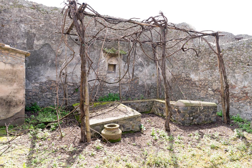 I.13.2 Pompeii. March 2023. 
Looking south across summer triclinium towards south wall with lararium niche. Photo courtesy of Johannes Eber.
