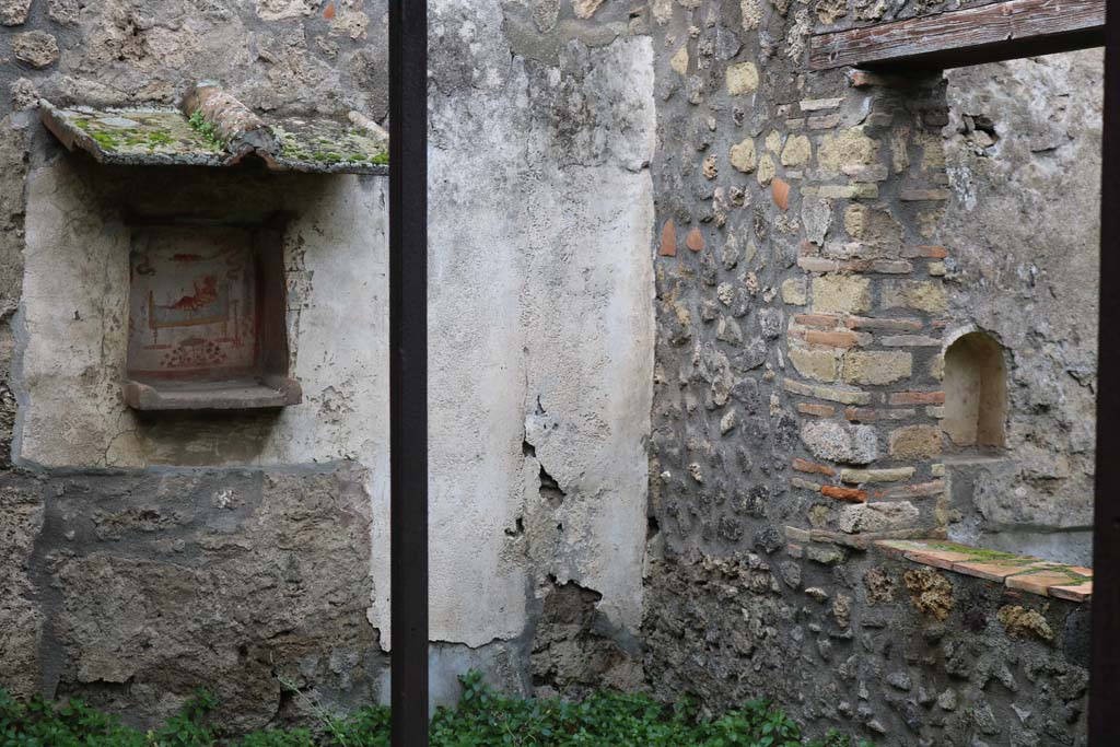 I.14.7 Pompeii. December 2018. 
Looking towards niche lararium in west wall of garden area, and niche in west wall of triclinium. Photo courtesy of Aude Durand.