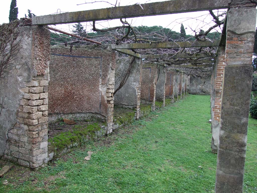 II.4.6 Pompeii. December 2006. Niches in pergola on east side of garden, looking south.
The south wall, in the distance, would have been where the under-mentioned sacrarium was found.
On the 15th June 1755 (PAH I, 1, 21, add. 98), it was reported that a small room was discovered in the south wall of the garden.
The sacrarium was thought to be dedicated to Egyptian deities.
This had been excavated on 13th June. 
The room was completely painted and included paintings of Isis, Serapis, Anubis and Fortuna. 
In the south wall was an altar of white marble.
Also found in this room was the bronze tripod supported by ithyphallic satyrs.
Several other smaller items in gold, bronze and ivory were also found.
See Pagano, M. and Prisciandaro, R., 2006. Studio sulle provenienze degli oggetti rinvenuti negli scavi borbonici del regno di Napoli. Naples: Nicola Longobardi, (p. 17 and note 43).