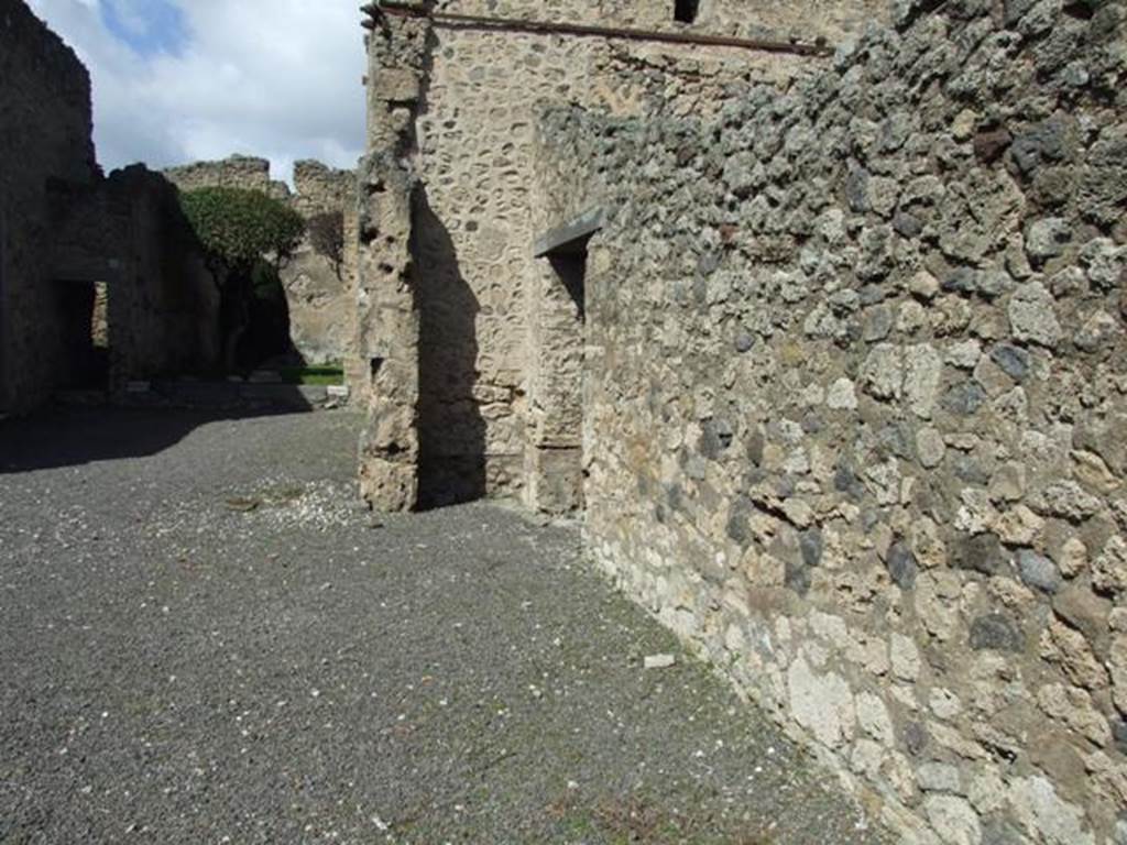 V.2.1 Pompeii. March 2009. Room 1, east side of atrium, looking north to lararium recess and room 3.
According to Boyce –
Within a recess on the north side of the atrium, to the right of the tablinum, is a lararium painting divided into three zones.
See Boyce G. K., 1937. Corpus of the Lararia of Pompeii. Rome: MAAR 14. (p.33, no.83).