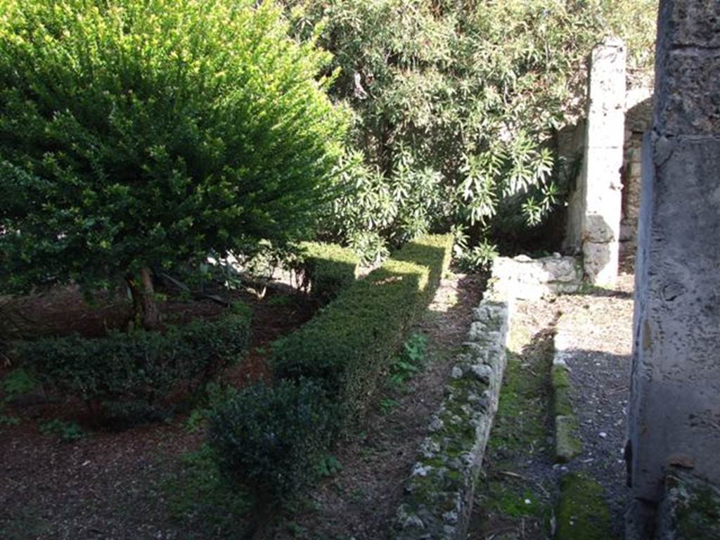 V.2.4 Pompeii. December 2007. Room 13, peristyle drainage channel, looking east towards south-east corner. According to Boyce, in the south-east corner of the garden were painted the two familiar serpents. One on each wall, one on the south and one on the east wall. The altar was painted between them in the corner of the wall. The serpents were brown and yellow on a white ground.
See Boyce G. K., 1937. Corpus of the Lararia of Pompeii. Rome: MAAR 14.  (p.34, no.88)