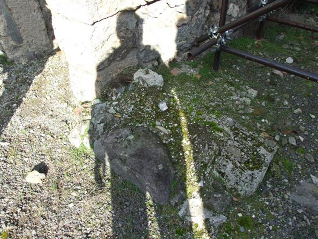 V.2.10 Pompeii. December 2007. Stone base on north-west corner of room 8.
According to Boyce –
In the front portico of the peristyle, on the east wall between the stair and the door to an adjacent room, a mass of masonry stands against the wall (w.1.22, d.0.60), flanked by two heavy antae, the height of which cannot be determined. Probably they rose to a height of about one metre and upon them rested a vault or some sort of roof and this was the aedicula for the domestic worship.
See Boyce G. K., 1937. Corpus of the Lararia of Pompeii. Rome: MAAR 14. (92, p. 34) 
According to NdS, between the rustic room 8, and the stairs to the upper floor, was a recessed seat between two walls and built against the dividing room pilaster.
See Notizie degli Scavi di Antichità, 1896, (p.437)